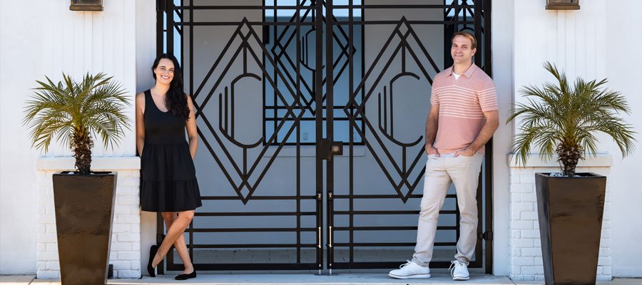 Award-winning real estate duo Brady and Alyssa Hammond on Artenzza Magazine cover, showcasing their journey from schoolteachers to TV personalities in Northeast Florida.